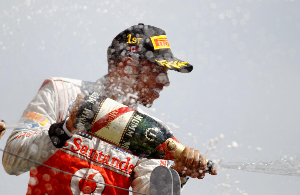 MONTREAL, CANADA - JUNE 10: Lewis Hamilton of Great Britain and McLaren celebrates on the podium after winning the Canadian Formula One Grand Prix at the Circuit Gilles Villeneuve on June 10, 2012 in Montreal, Canada. (Photo by Paul Gilham/Getty Images)