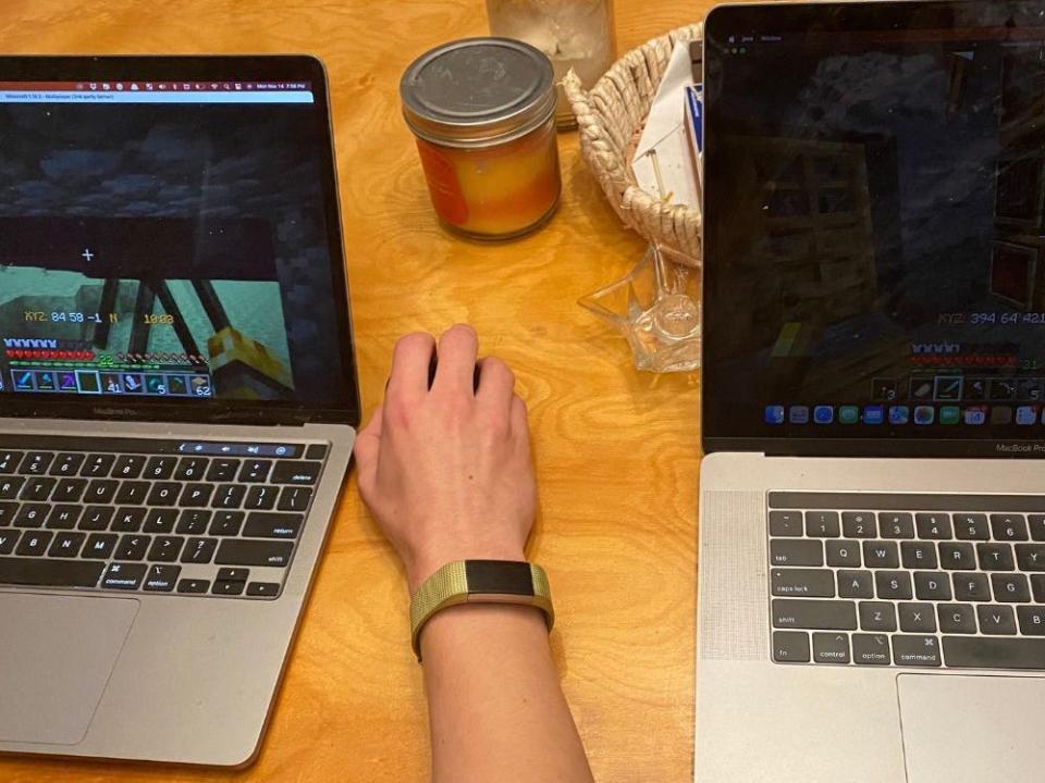 two laptops with minecraft on the screen on a table at the tanner's house