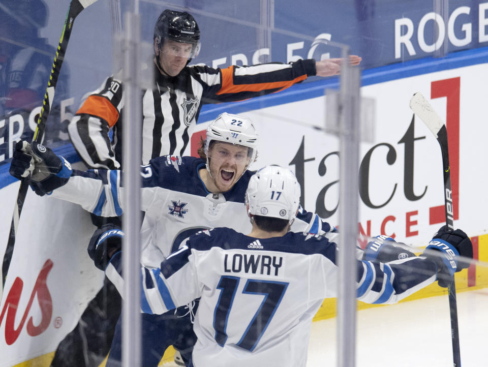 Winnipeg Jets center Mason Appleton (22) celebrates his goal with left wing Adam Lowry (17) during second-period NHL hockey game action against the Toronto Maple Leafs in Toronto, Saturday, March 13, 2021. (Frank Gunn/The Canadian Press via AP)