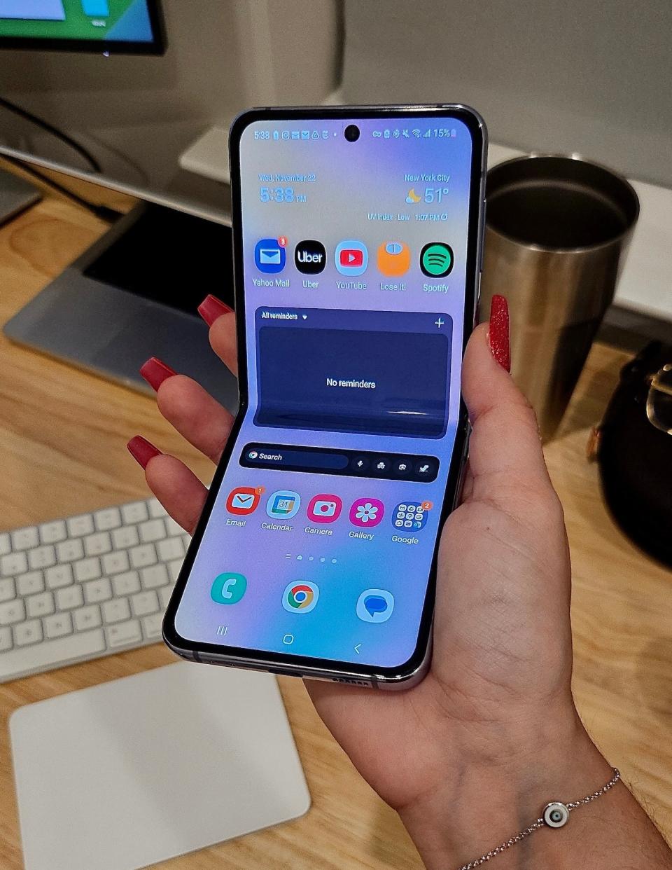 author holding the Flip 4 folded around 90 degrees displaying the home screen