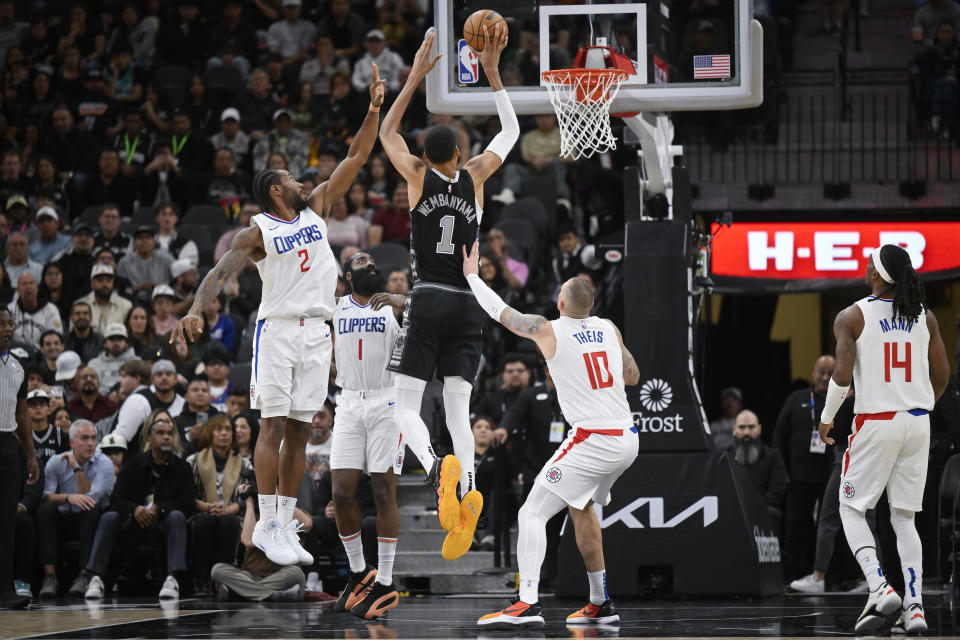 San Antonio Spurs' Victor Wembanyama (1) dunks against the Los Angeles Clippers during the first half of an NBA basketball game Wednesday, Nov. 22, 2023, in San Antonio. (AP Photo/Darren Abate)