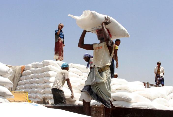 Men deliver U.N. World Food Program (WFP) aid in Aslam, Hajjah, Yemen. The World Food Program won the 2020 Nobel Peace Prize for its efforts to combat hunger and food insecurity around the globe.