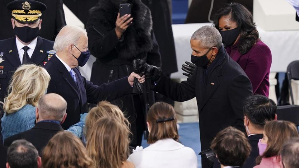 U.S. President-elect Joe Biden, left, greets former U.S. President Barack Obama, right, with a fist bump during the inauguration on the West Front of the U.S. Capitol on January 20, 2021 in Washington, DC. (Photo by Kevin Dietsch-Pool/Getty Images)