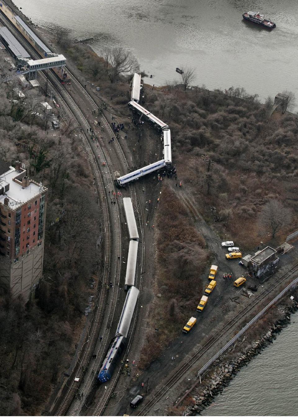 FILE - In this Dec. 1, 2013 file photo, a Metro-North passenger train lays on it's side after derailing on a curved section of track in the Bronx borough of New York. Federal investigators say William Rockefeller, who was engineer on a New York commuter train that derailed last year, killing four people, has a serious sleep disorder. A medical document made available Monday April 7, 2014, by the National Transportation Safety Board says he has "severe obstructive sleep apnea." The NTSB did not say whether the engineer's disorder contributed to the crash.( (AP Photo/Mark Lennihan, File)