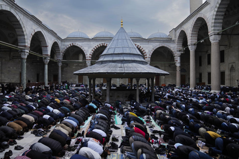 Muslims pray as they celebrate Eid al-Fitr, marking the end of the Muslim holy fasting month of Ramadan at Fatih mosque in Istanbul, Turkey, Friday, April 21, 2023. (AP Photo/Khalil Hamra)