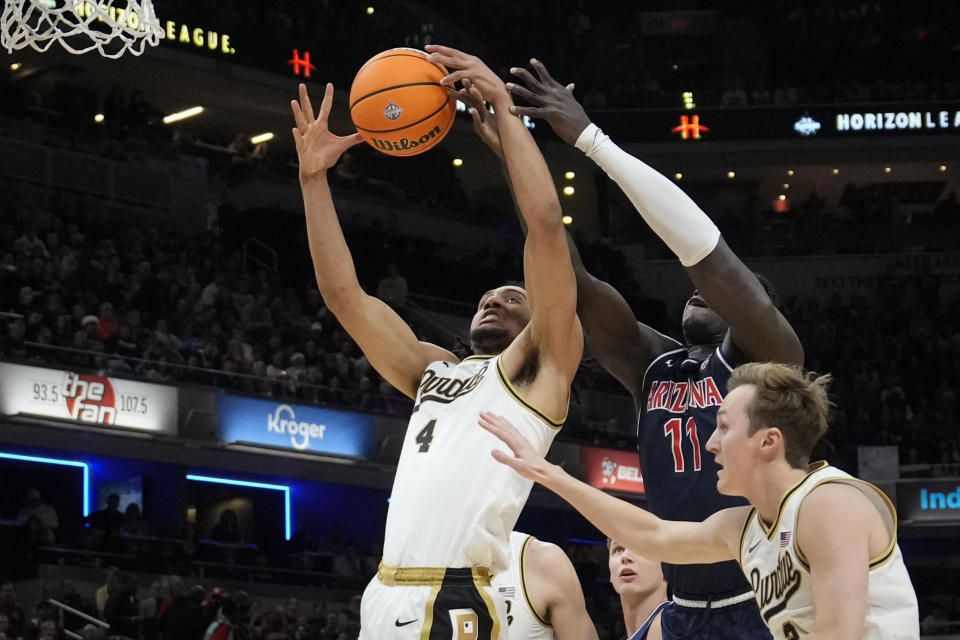 Purdue forward Trey Kaufman-Renn (4) battels for a rebound with Arizona center Oumar Ballo (11) in the first half of an NCAA college basketball game in Indianapolis, Saturday, Dec. 16, 2023. (AP Photo/AJ Mast)