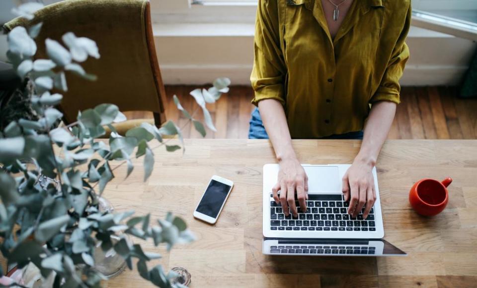 Overhead image of a female blogger writing on the laptop