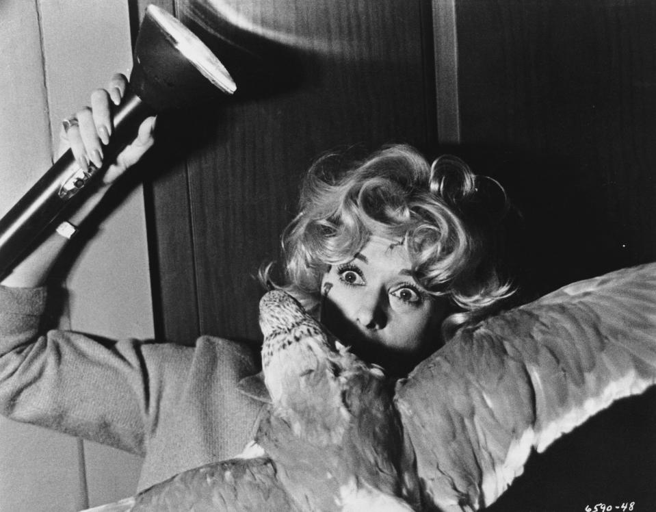 Melanie Daniels (Tippi Hedren) fights off an attacking gull in Alfred Hitchcock's The Birds