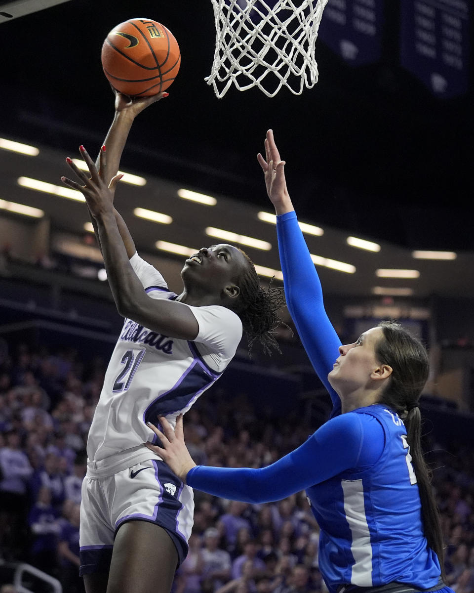 Kansas State forward Eliza Maupin (21) gets past BYU forward Emma Calvert to put up a shot during the second half of an NCAA college basketball game Saturday, Jan. 27, 2024, in Manhattan, Kan. Kansas State won 67-65. (AP Photo/Charlie Riedel)