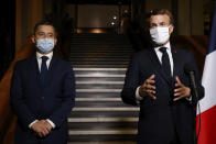 French President Emmanuel Macron, right, delivers a speech while Interior Minister Gerald Darmanin listens, after a visit on the fight against separatism at the Seine Saint Denis prefecture headquarters in Bobigny, a northeastern suburbs of Paris, Tuesday Oct. 20, 2020. Authorities were looking into about 50 associations suspected of encouraging hate speech and the issue will be discussed at a Cabinet meeting Wednesday after the history teacher Samuel Paty was beheaded on Friday by an 18-year-old Moscow-born Chechen refugee. (Ludovic Marin, Pool via AP)