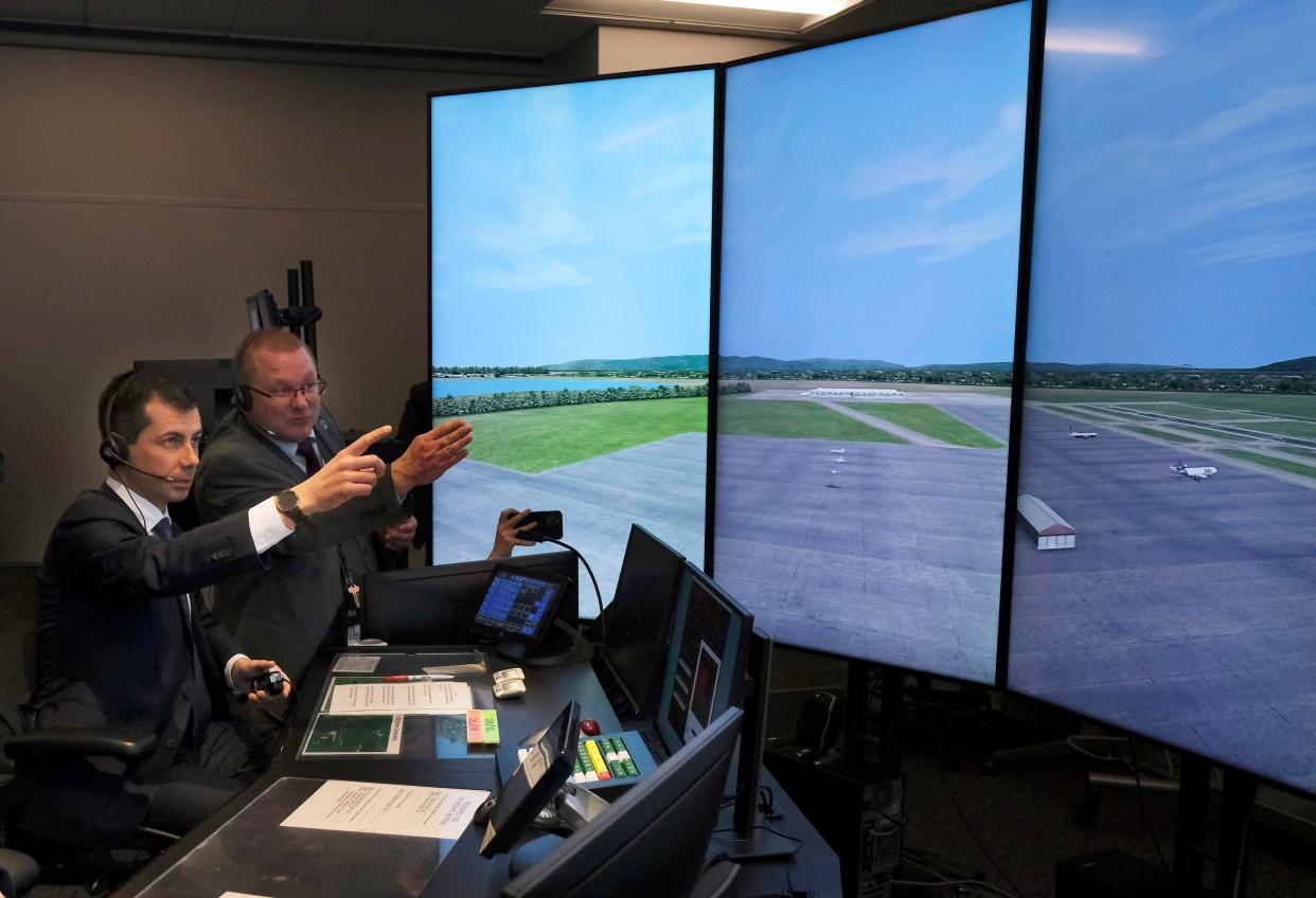 Luther "Dewayne" Davis, right, coaches U.S. Transportation Secretary Pete Buttigieg during an air traffic controller simulation. Buttigieg toured the Mike Monroney Aeronautical Center in Oklahoma City and spoke with air traffic controller trainees and FAA employees at a town hall meeting.