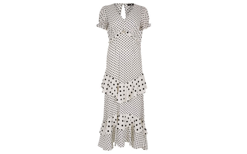 Who said you can't tackle the dress code while looking after your pennies? We'll be teaming this polka dot number with a red lip and '90s strappy heels. <a href="https://www.riverisland.com/p/white-and-black-spot-print-frill-maxi-dress-734063?t168=t168-search-plp" rel="nofollow noopener" target="_blank" data-ylk="slk:Shop now;elm:context_link;itc:0;sec:content-canvas" class="link "><em>Shop now</em></a>.