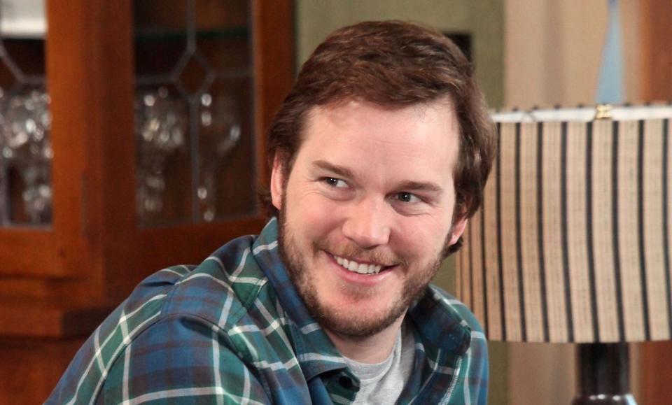 Andy smiling in a green plaid shirt in "Parks and Recreation"