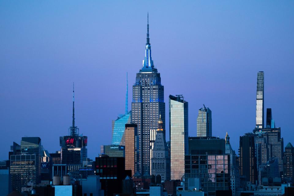 The Empire State Building glows blue during dusk, Monday, Nov. 14, 2022, in New York.