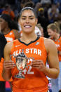 Team Wilson's Kelsey Plum holds up the MVP trophy after team Wilson defeated Team Stewart in a WNBA All-Star basketball game in Chicago, Sunday, July 10, 2022. (AP Photo/Nam Y. Huh)
