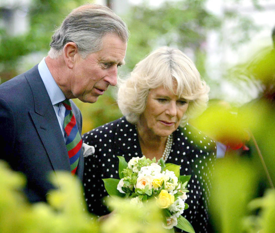 Camilla, Duchess of Cornwall and Prince Charles, Prince of Wales admire flowers on display at Chelsea Flower Show in London (Photo by © Pool Photograph/Corbis/Corbis via Getty Images)