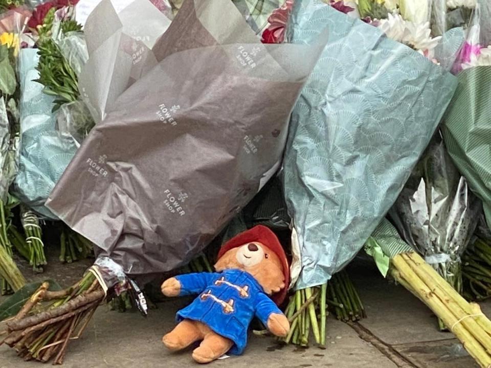 A Paddington Bear is found among the flowers outside the palace (Stephen Downer)