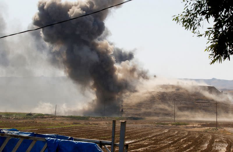 FILE PHOTO: Smoke rises from the Iraqi Kurdistan headquarters of the Kurdistan Freedom Party