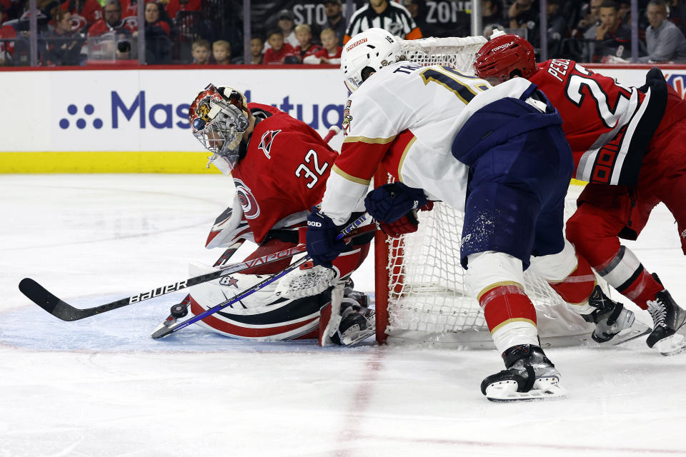 Carolina Hurricanes goaltender Antti Raanta (32) blocks the shot of Florida Panthers' Matthew Tkachuk (19) with Hurricanes' Brett Pesce (22) nearby during the third period of Game 2 of the NHL hockey Stanley Cup Eastern Conference finals in Raleigh, N.C., Saturday, May 20, 2023. (AP Photo/Karl B DeBlaker)