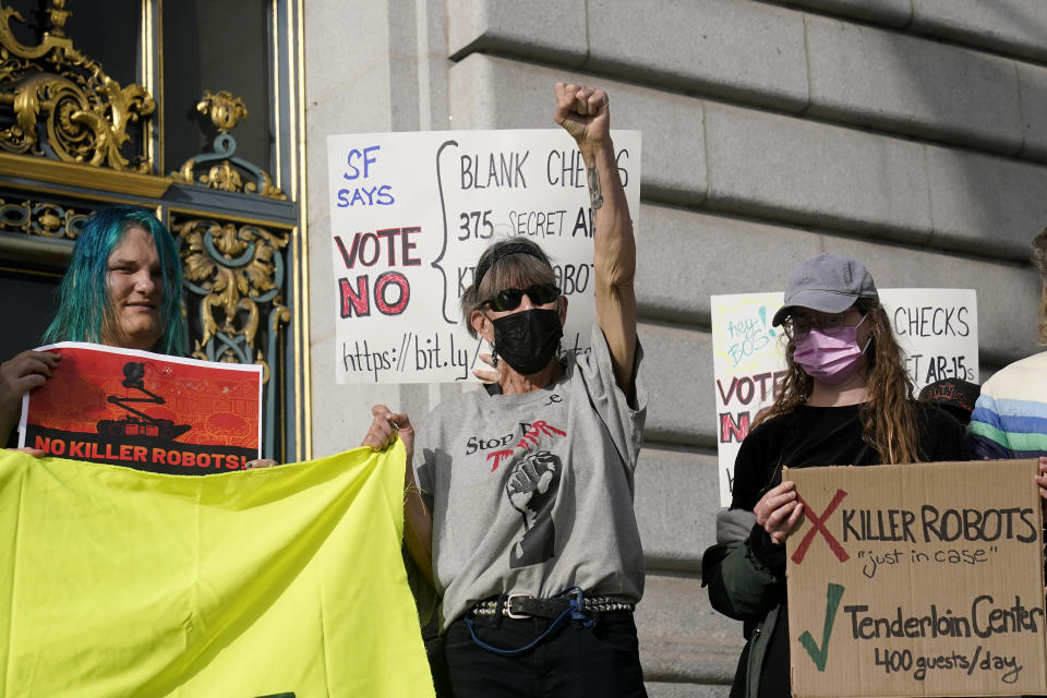 Denise Dorey, middle, reacts to speakers while taking part in a demonstration about the use of robots by the San Francisco Police Department outside of City Hall in San Francisco, Monday, Dec. 5, 2022. The unabashedly liberal city of San Francisco became the unlikely proponent of weaponized police robots this week after supervisors approved limited use of the remote-controlled devices, addressing head-on an evolving technology that has become more widely available even if it is rarely deployed to confront suspects. (AP Photo/Jeff Chiu)