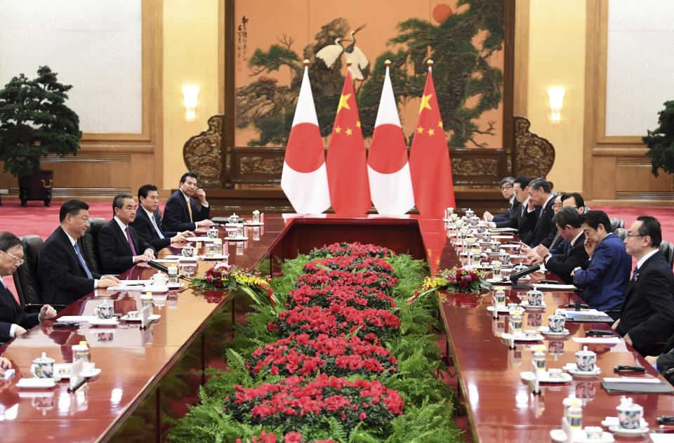 Japan's Prime Minister Shinzo Abe, second right, talks to China's President Xi Jinping, second left, during a meeting at the Great Hall of the People in Beijing, Monday, Dec. 23, 2019. (Noel Celis/Pool Photo via AP)