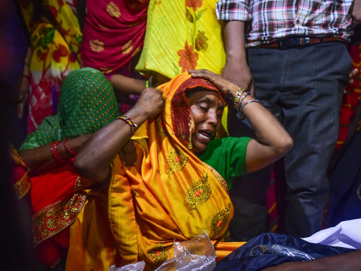 Relatives mourn victims of the Hathras stampede during a cremation ceremony at Daukeli village  in Hathras, India (Getty)