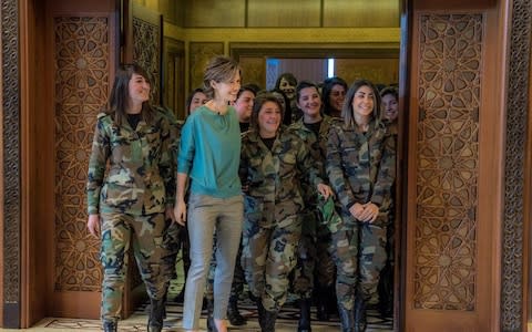 Bashar al-Assad's wife Asma with female troops on the occasion of Mother's Day in a picture distributed by the Syrian Government  - Credit: Twitter