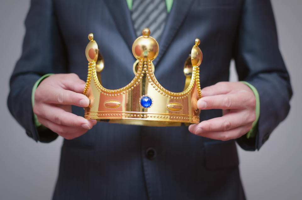 Businessman holding a crown