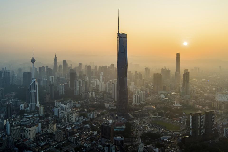 The sun rises over downtown Kuala Lumpur, Malaysia on April 11, 2023. (AP Photo/Vincent Thian)