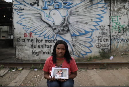 Maira Medeiros shows a picture taken on the day of her wedding to Andre Luis Medeiros, who was killed one year ago, in the Jacarezinho slum in Rio de Janeiro, Brazil, October 1, 2018. REUTERS/Pilar Olivares