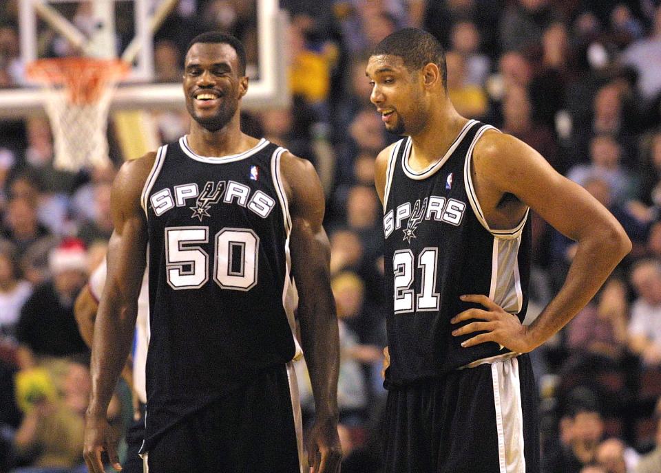 SEATTLE, UNITED STATES:  San Antonio Spurs David Robinson (L) and Tim Duncan (R) breath sighs of relief after they completed an 