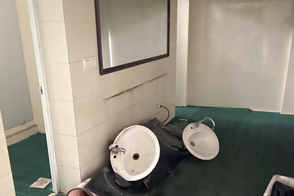 In this photo provided by Qiu Xin, damaged sinks and plumbing fixtures are seen in a bathroom of an office building after an earthquake in Luzhou in southwestern China's Sichuan Province, Thursday, Sept. 16, 2021. Rescue work was underway following a magnitude-6.0 earthquake early Thursday in southwest China's Sichuan province. (Qiu Xin via AP)