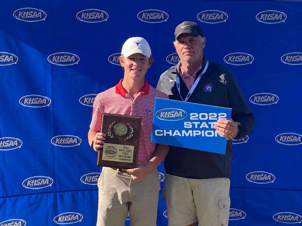 Christian Academy golfer Brady Smith stands alongside coach Jeff Imlay after winning the KHSAA boys golf individual championship in 2022 at Bowling Green Country Club. Smith is in contention again this year.