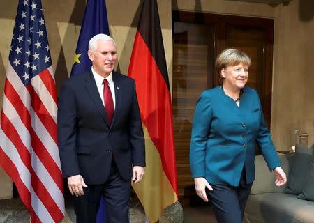 German Chancellor Angela Merkel walks with U.S. Vice President Mike Pence before their meeting at the 53rd Munich Security Conference in Munich, Germany, February 18, 2017. REUTERS/Michael Dalder