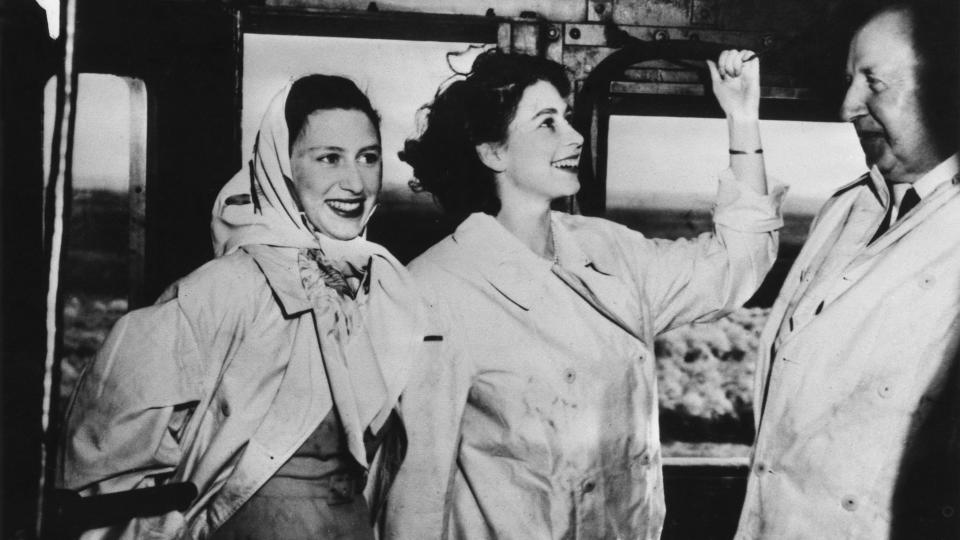 Princess Elizabeth and Princess Margaret travel on the footplate of a steam engine which is towing the royal train across South Africa, February 1947. On the right is F. C. Sturrock, the South African Minister of Transport.