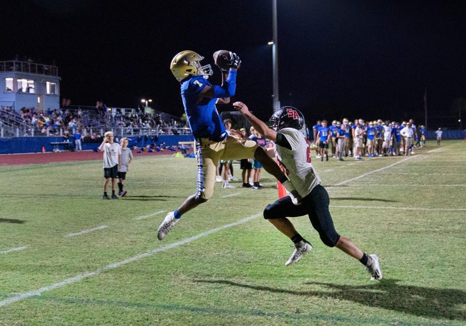 Cardinal Newman's Kevin Levy catches a touchdown pass over St. Andrew's Ben Balshi in last Friday's 3A regional playoff game in West Palm Beach.