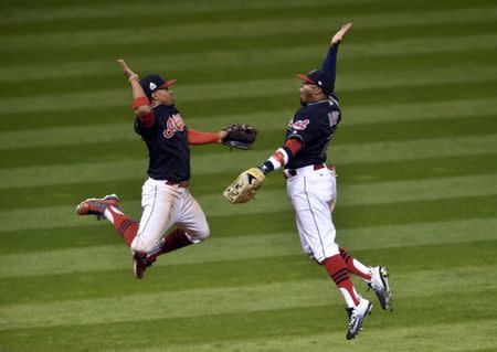Oct 25, 2016; Cleveland, OH, USA; Cleveland Indians shortstop Francisco Lindor (12) celebrates with center fielder Rajai Davis (20) after defeating the Chicago Cubs in game one of the 2016 World Series at Progressive Field. Mandatory Credit: David Richard-USA TODAY Sports - RTX2QGFR