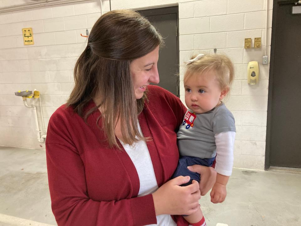 Tammy Gossen, a kindergarten teacher with De Pere Learning Lab, smiles at her 9-month-old daughter Ainsley Gossen at De Pere Fire Station on Friday. Tammy went into emergency labor and gave birth to Ainsley five minutes later, with assistance from her husband and a whole team of De Pere firefighters, police and emergency responders.