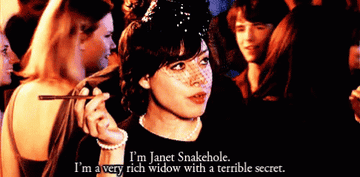 April embracing her alter-ego and saying "I'm Janet Snakehole. I'm a very rich widow with a terrible secret."