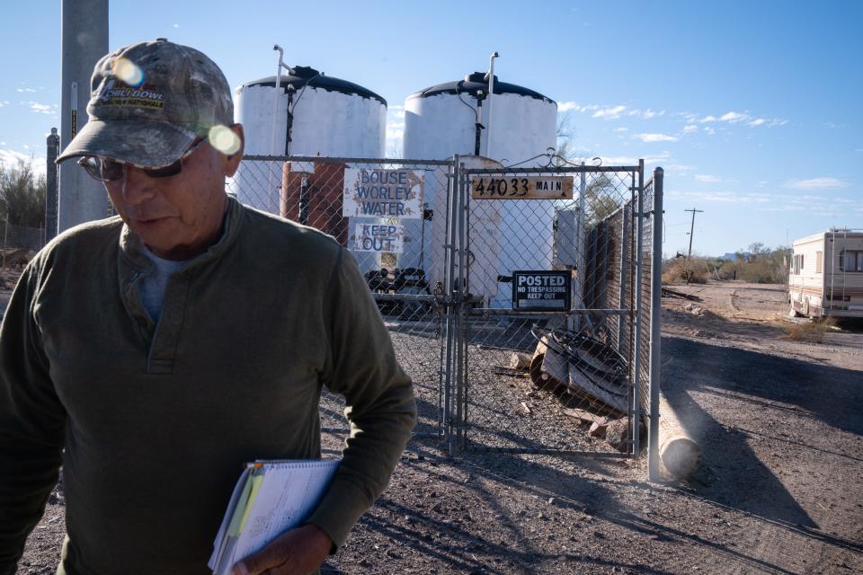 John Bennett takes his monthly meter readings, March 1, 2022, at the well in Bouse, Arizona.