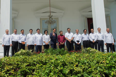 Indonesia's new ministers, (L-R) Trade Minister Enggartiasto Lukita, Transmigration Minister Eko Putro Sandjojo, Coordinating Minister for Legal, Security and Politics Wiranto, Administrative and Bureaucratic Reform Minister Asman Abnur, Industry Minister Airlangga Hartarto, Finance Minister Sri Mulyani Indrawati, President Joko Widodo, Vice President Jusuf Kalla, Coordinating Minister for Maritime Luhut Panjaitan, Energy and Mining Minister Archandra Tahar, Agrarian Minister Sofyan Djalil, Transportation Minister Budi Karya Sumadi, and Education Minister Muhadjir Effendy pose for photographers during the announcement of the new cabinet at Presidential Palace in Jakarta, Indonesia, July 27, 2016. Antara Foto/Widodo S Jusuf/via REUTERS ATTENTION EDITORS - THIS IMAGE WAS PROVIDED BY A THIRD PARTY. FOR EDITORIAL USE ONLY. MANDATORY CREDIT. INDONESIA OUT. NO COMMERCIAL OR EDITORIAL SALES IN INDONESIA.