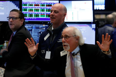 Traders joke around on the floor of the New York Stock Exchange (NYSE) in New York, U.S., March 10, 2017. REUTERS/Brendan McDermid