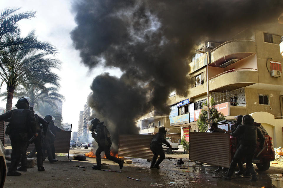 Egyptian security forces clash with supporters of ousted President Mohamed Morsi in the Nasr City district of Cairo, Egypt, Friday Jan. 10, 2014. Hundreds of Islamists rallied in Egypt’s capital and across the country Friday, calling for a boycott of an upcoming constitutional referendum and clashing with security forces, with a bystander being killed, an official said. (AP Photo/Ahmed Abd El Latif, El Shouk Newspaper) EGYPT OUT