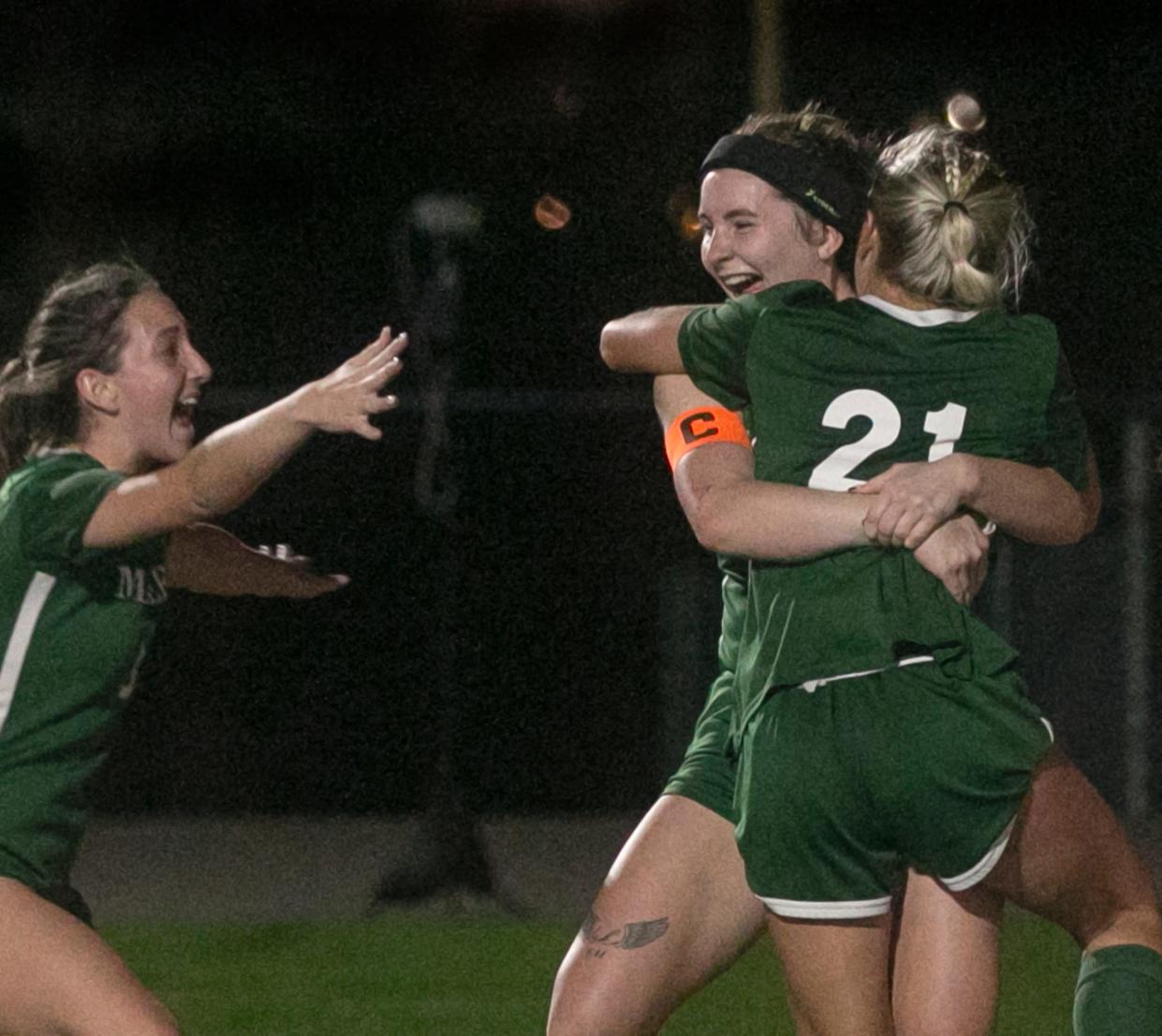 McKeel's Kadence Rinaldo (4), center, hugs Maddi Caustic (21), right, as Sophia Furnari (5), left, cheers after Rinaldo scored the game winning goal with nearly three minutes left in the second half during their FHSAA Class 4A Region 3 Final girls soccer match against Academy of the Holy Names at McKeel Academy in Lakeland Tuesday nigh. February 14, 2023