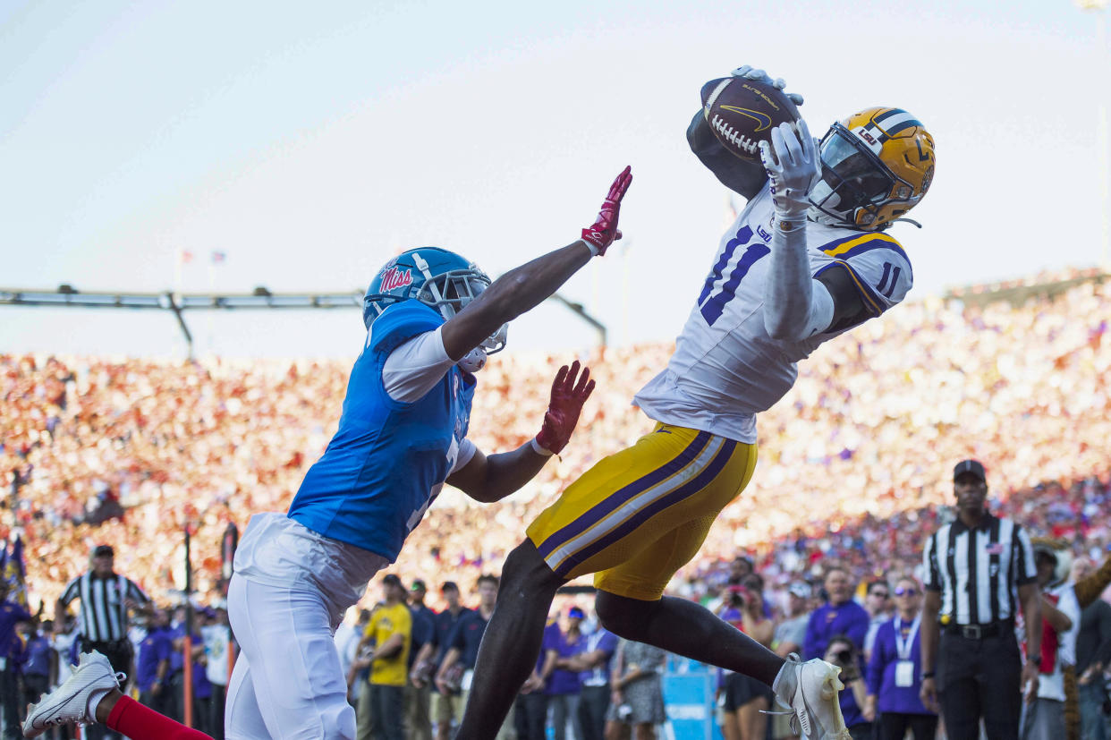 OXFORD, MISSISSIPPI - SEPTEMBER 30: Wide receiver Brian Thomas Jr. #11 of the LSU Tigers catches a pass for a touchdown in front of cornerback Deantre Prince #7 of the Mississippi Rebels during the first half of play at Vaught-Hemingway Stadium on September 30, 2023 in Oxford, Mississippi. (Photo by Michael Chang/Getty Images)