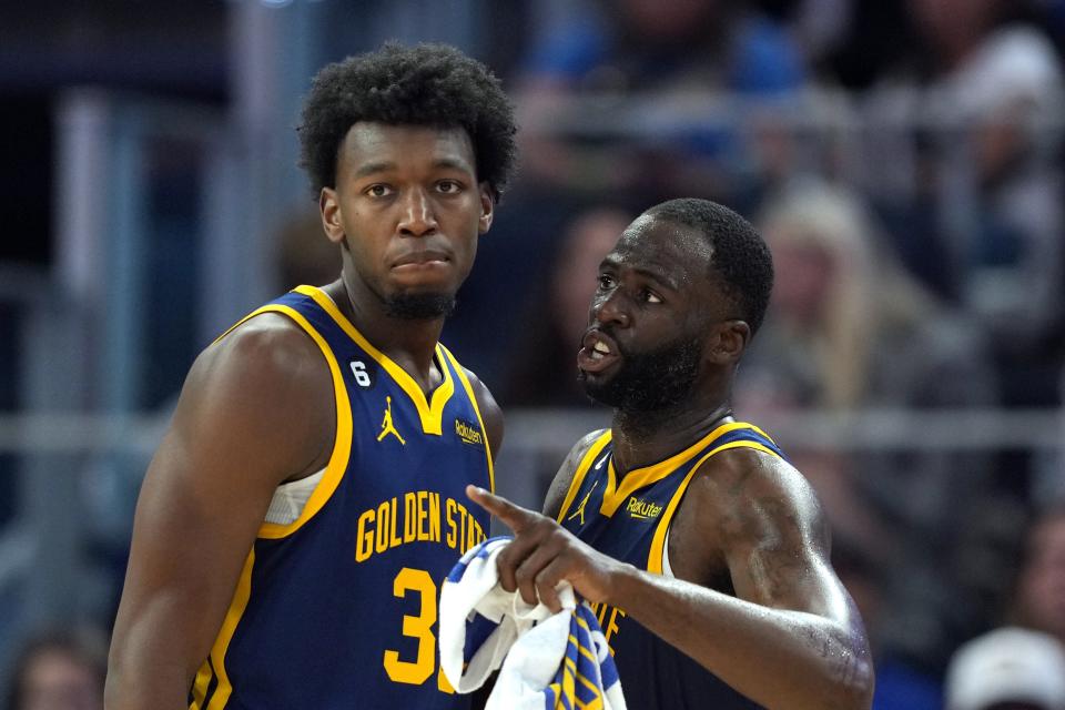 Golden State Warriors forward Draymond Green, right, talks to center James Wiseman, left, during the third quarter against the Sacramento Kings at Chase Center, Oct. 23, 2022 in San Francisco.