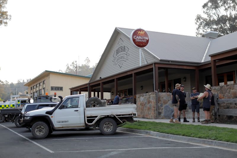 People gather outside the Buchan Caves Hotel in Buchan, Victoria, Australia