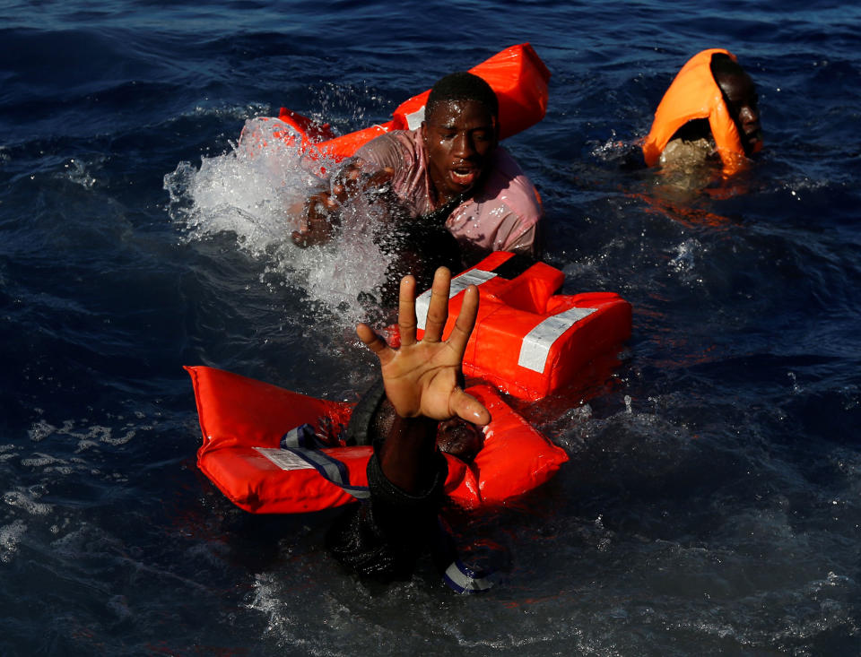 <p>APR. 14, 2017 – Migrants try to stay afloat after falling off their rubber dinghy during a rescue operation by the Malta-based NGO Migrant Offshore Aid Station (MOAS) ship in the central Mediterranean in international waters some 15 nautical miles off the coast of Zawiya in Libya. All 134 sub-Saharan migrants survived and were rescued by MOAS. (Photo: Darrin Zammit Lupi/Reuters) </p>