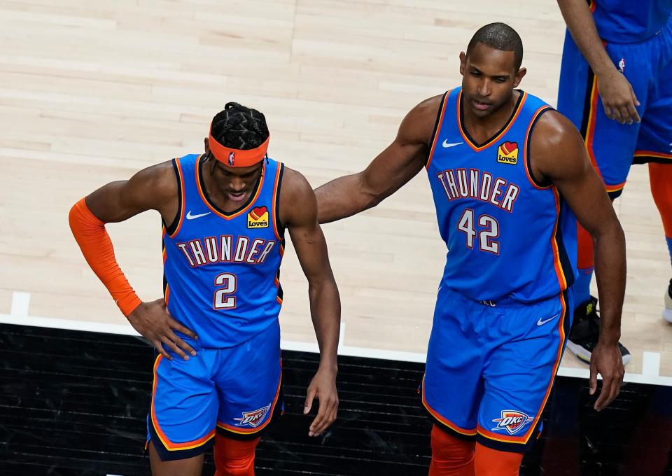 Oklahoma City Thunder guard Shai Gilgeous-Alexander (2) and Al Horford (42) deject after a foul was called on Gilgeous-Alexander during the second half of an NBA basketball game on Thursday, March 18, 2021, in Atlanta. (AP Photo/Brynn Anderson)