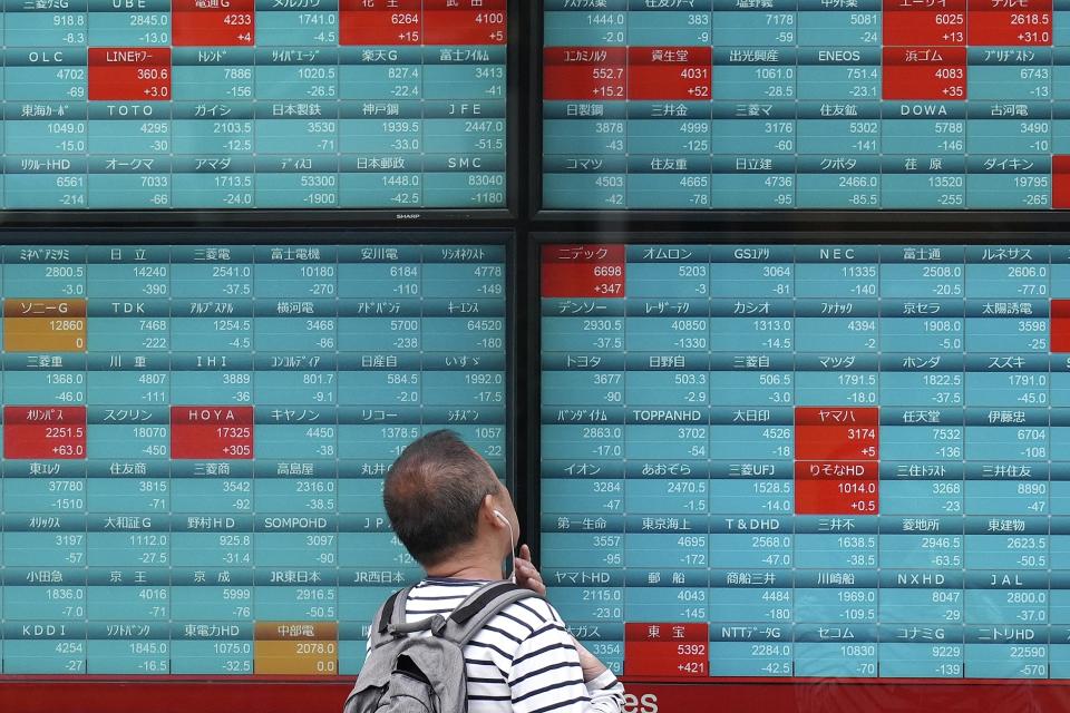 A person looks at an electronic stock board showing Japan's Nikkei 225 index at a securities firm Tuesday, April 16, 2024, in Tokyo. (AP Photo/Eugene Hoshiko)